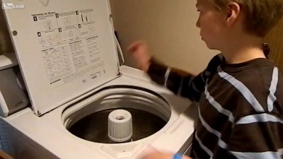 autistic boy drumming on washing machi