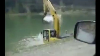 Купание экскаватора после тяжёлого трудового дня .