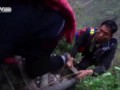 Children climb rattan ladder on a vertical cliff to get home from school