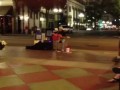 В огнях ночного города, живет.
